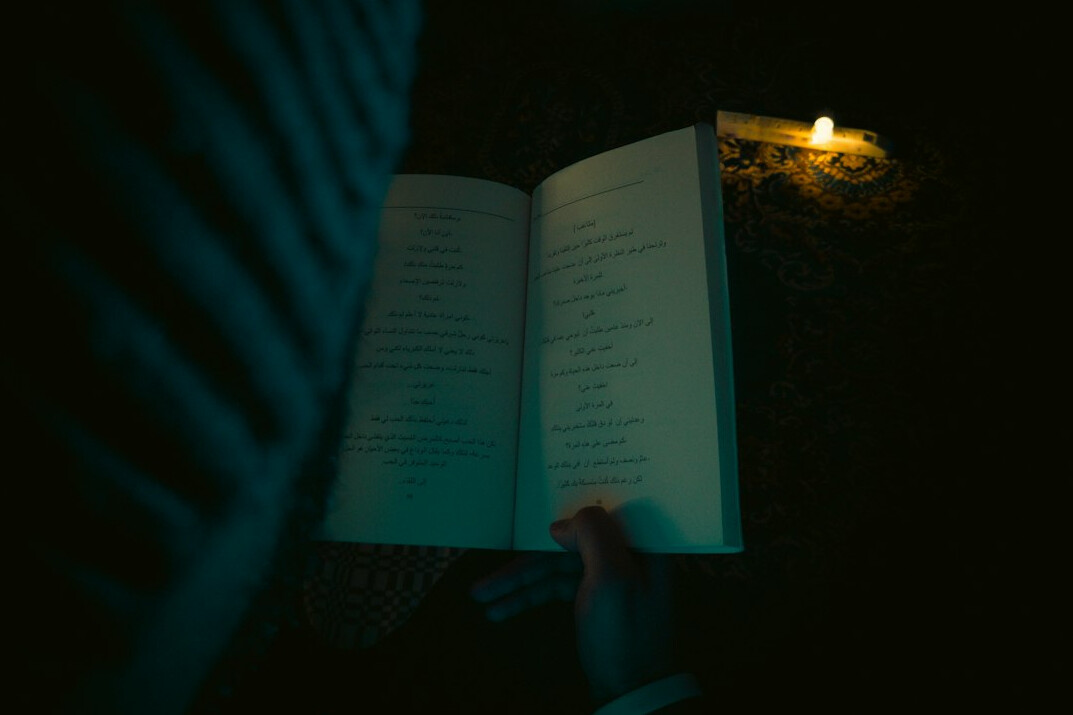 person reading mystery book at night